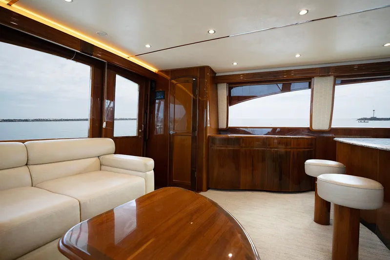 Serenity Now Yacht Photos Pics Luxurious interior of 2014 Viking 66 yacht with elegant wood finishes and plush seating.