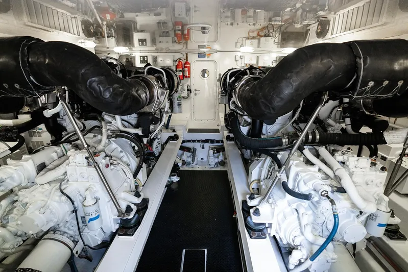 Serenity Now Yacht Photos Pics Engine room of a 2014 Viking 66 yacht, featuring dual engines and complex machinery.