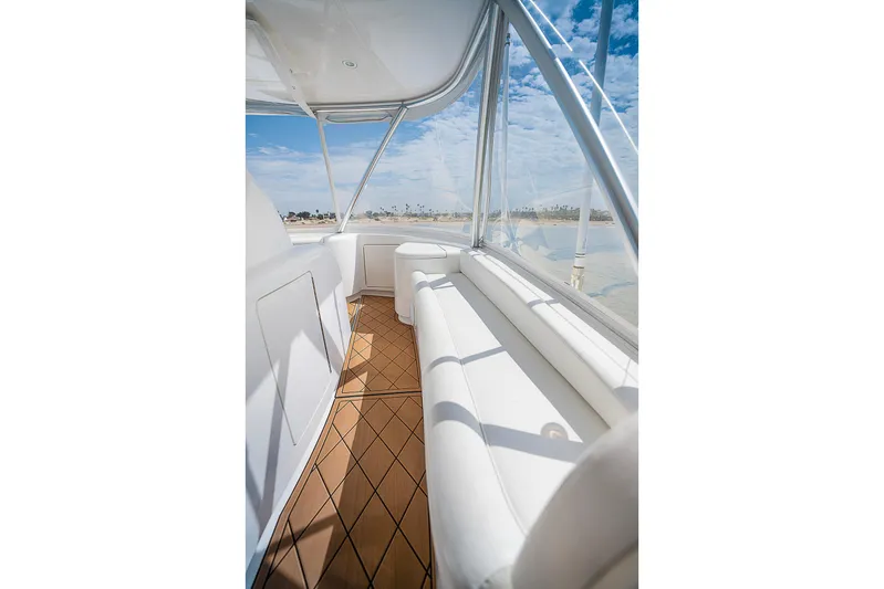 Serenity Now Yacht Photos Pics Luxurious interior of 2014 Viking 66 yacht with white seating and wooden flooring.
