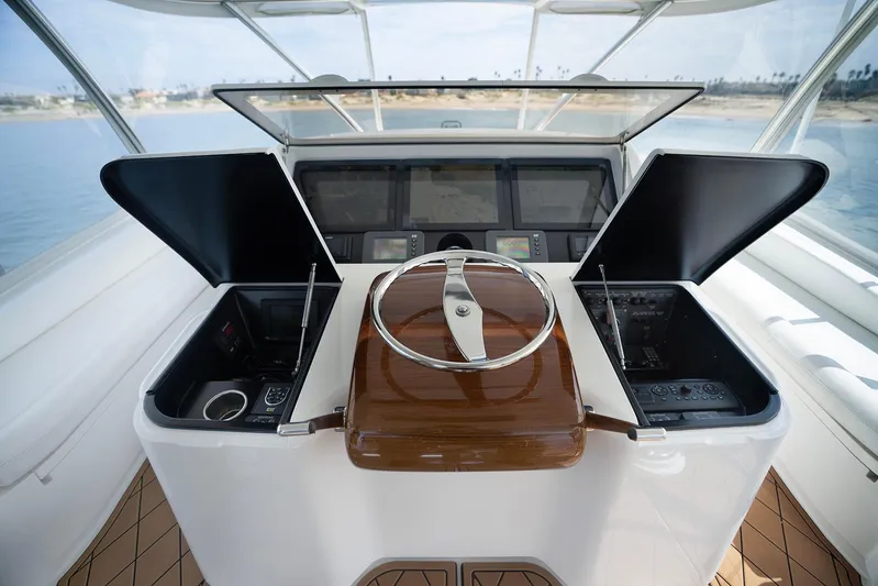 Serenity Now Yacht Photos Pics Helm of 2014 Viking 66 yacht with modern controls and wooden steering wheel.