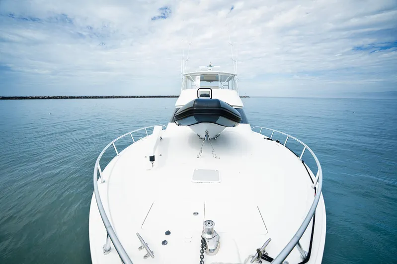 Serenity Now Yacht Photos Pics 2014 Viking 66 yacht on calm ocean under cloudy sky.