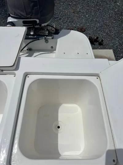  Yacht Photos Pics Open storage compartment on a 2015 Ocean Master 296 boat, with visible engine.