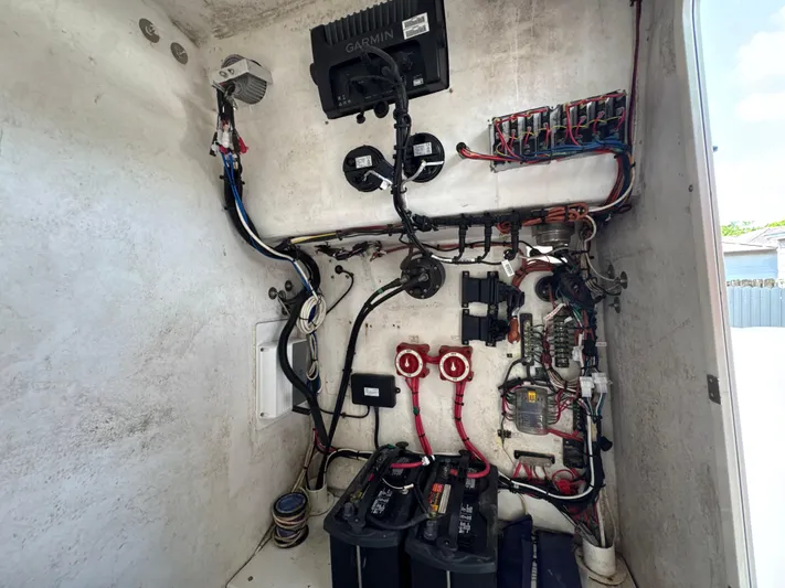  Yacht Photos Pics Electrical system inside a 2015 Ocean Master 296 boat, featuring wiring and battery setup.