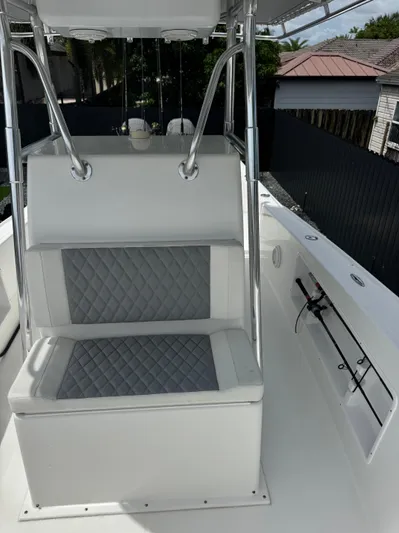  Yacht Photos Pics 2015 Ocean Master 296 boat interior with cushioned seating and rod holders.