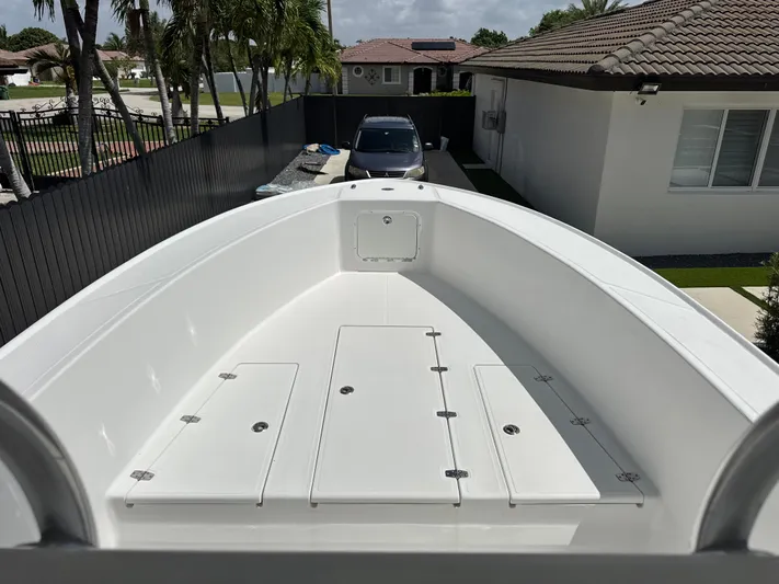  Yacht Photos Pics 2015 Ocean Master 296 boat in driveway, surrounded by palm trees and houses.