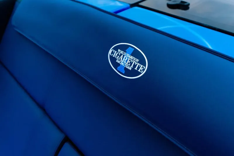  Yacht Photos Pics 2024 Cigarette 59 Tirranna interior with logo on blue upholstery.