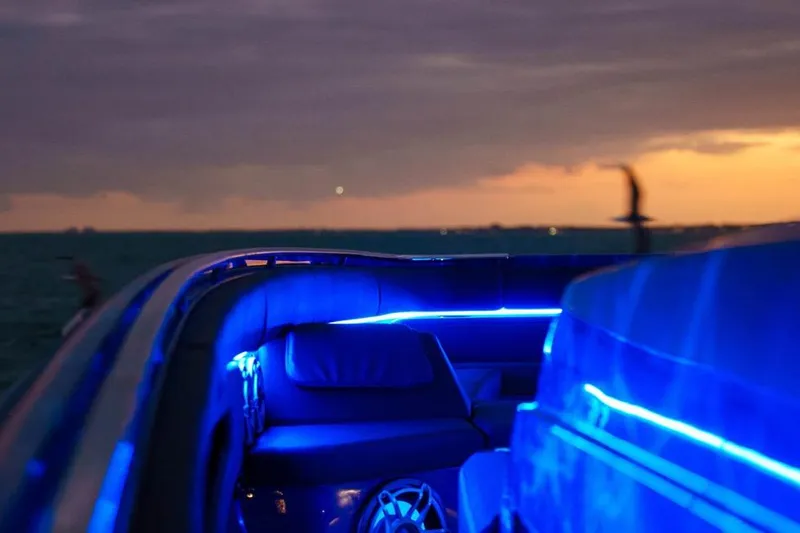  Yacht Photos Pics 2024 Cigarette 59 Tirranna boat interior with blue LED lighting at sunset.