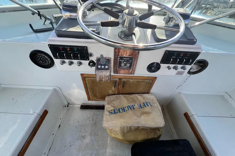 Grand Adventure Yacht Photos Pics 1972 Hatteras 58 Yacht Fisherman helm with steering wheel and control panel.