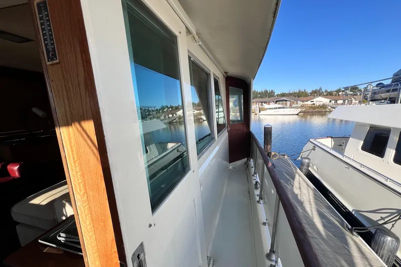 Grand Adventure Yacht Photos Pics 1972 Hatteras 58 Yacht Fisherman docked, showcasing side deck and marina view.