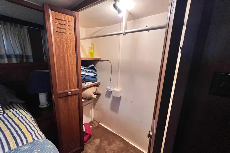 Grand Adventure Yacht Photos Pics Interior of 1972 Hatteras 58 Yacht Fisherman showing a small closet with shelves.