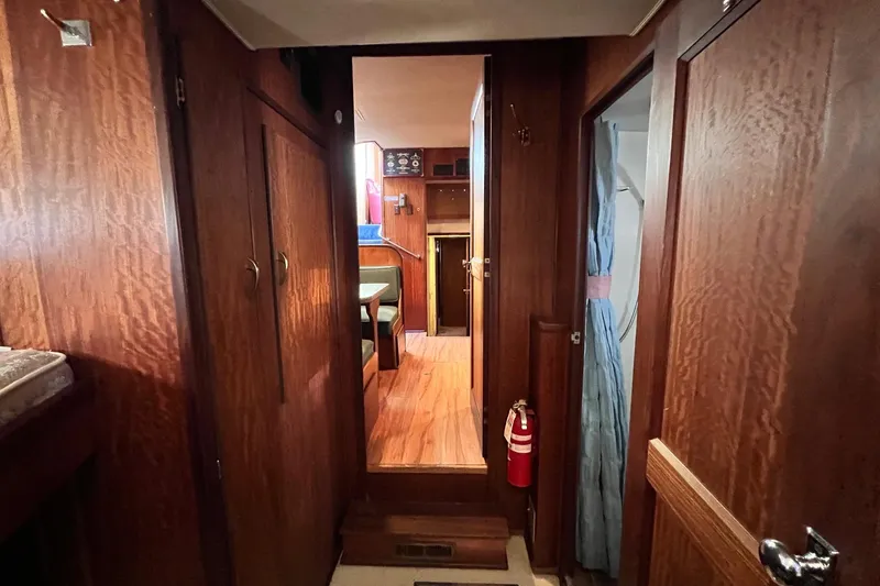 Grand Adventure Yacht Photos Pics Interior of 1972 Hatteras 58 Yacht Fisherman with wood paneling and cozy seating area.