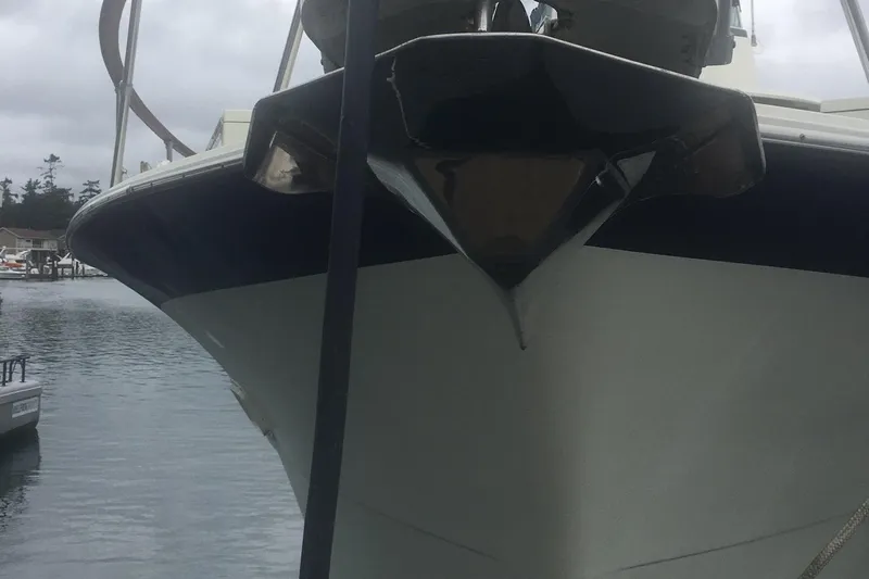 Grand Adventure Yacht Photos Pics Front view of a 1972 Hatteras 58 Yachtfish docked in a marina.