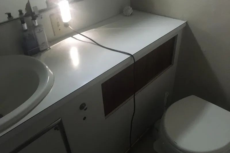 Grand Adventure Yacht Photos Pics 1972 Hatteras 58 Yachtfish bathroom with sink, countertop, and toilet.