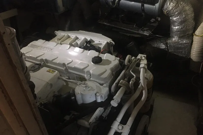 Grand Adventure Yacht Photos Pics Engine room of a 1972 Hatteras 58 Yachtfish, featuring a white marine engine.