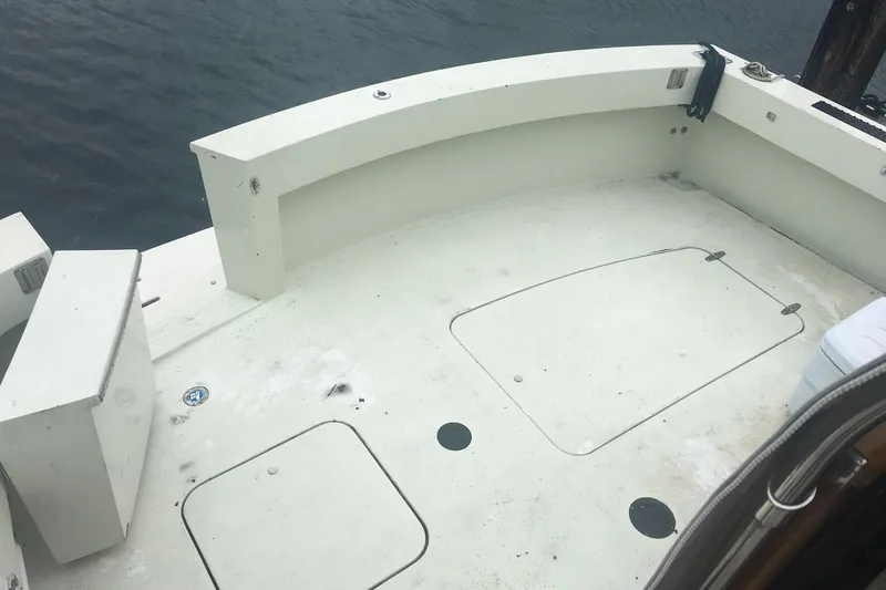 Grand Adventure Yacht Photos Pics 1972 Hatteras 58 Yachtfish deck, featuring spacious white surface and storage hatches.