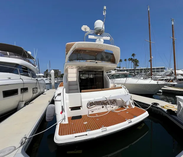 Sea Banshee Yacht Photos Pics Viking Princess 52 Flybridge yacht, 2000 model, docked at marina under clear blue sky.