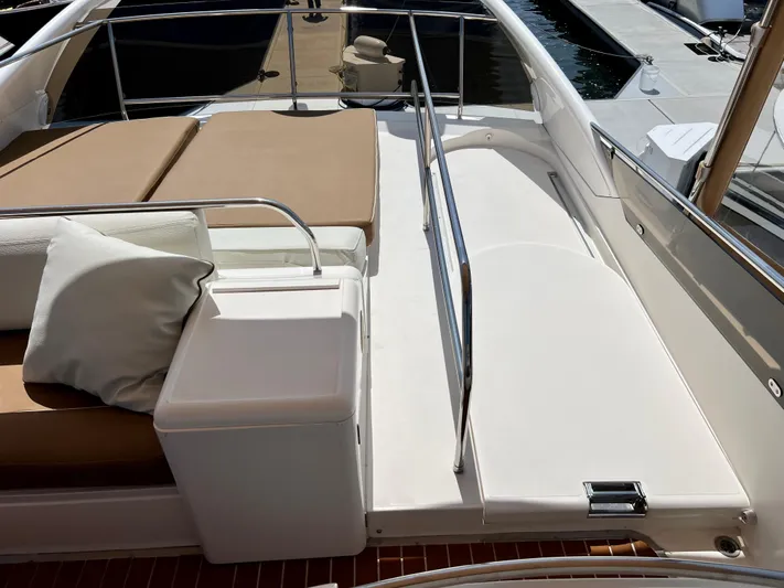 Sea Banshee Yacht Photos Pics Flybridge seating area on a 2000 Viking Princess 52 yacht, featuring cushions and railing.