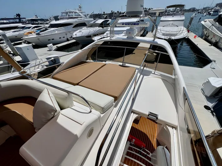 Sea Banshee Yacht Photos Pics Luxurious 2000 Viking Princess 52 Flybridge yacht docked at marina, featuring spacious sunbathing area.