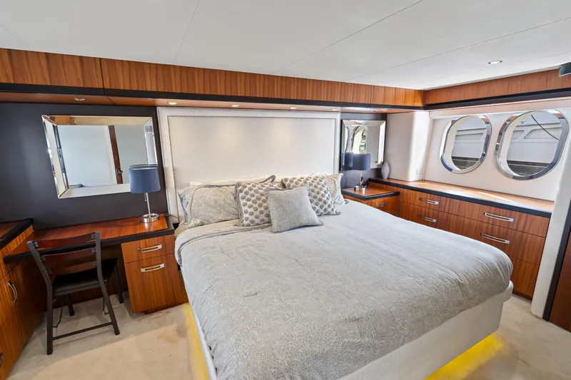 Elsewhere Yacht Photos Pics Luxurious bedroom interior of 2013 Hatteras 60 Motor Yacht with elegant wood finishes.