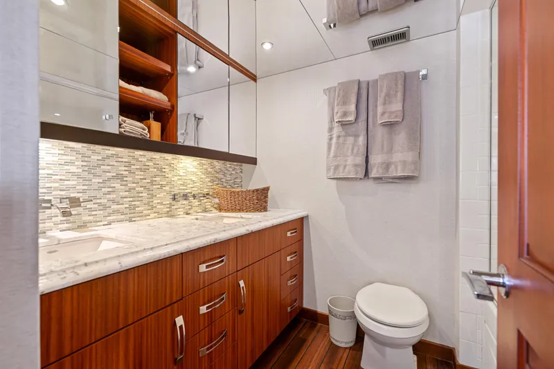 Elsewhere Yacht Photos Pics Luxurious bathroom in 2013 Hatteras 60 Motor Yacht with modern fixtures and elegant wood cabinetry.