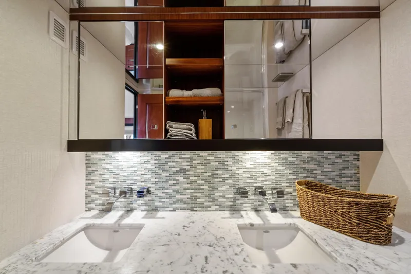 Elsewhere Yacht Photos Pics Luxurious bathroom in 2013 Hatteras 60 Motor Yacht with dual sinks and elegant tile backsplash.