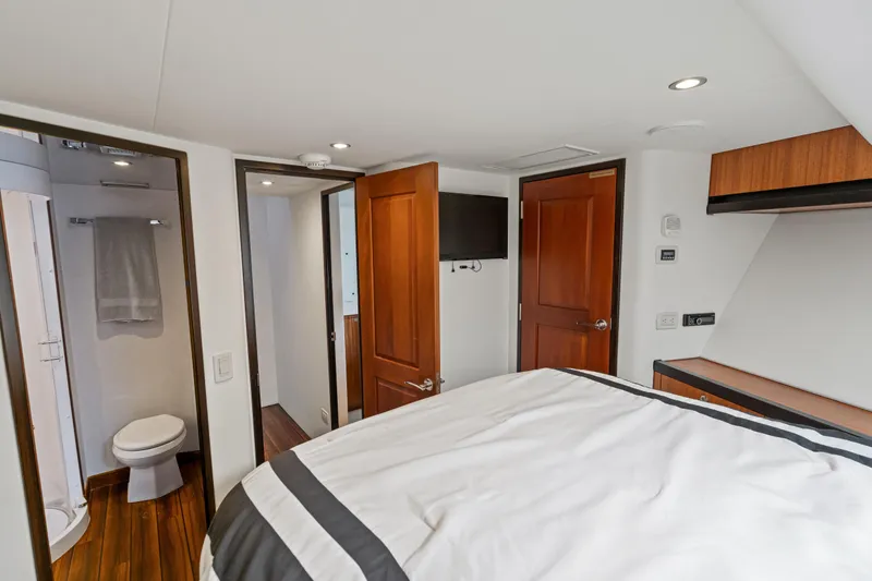 Elsewhere Yacht Photos Pics Luxurious bedroom and bathroom interior of 2013 Hatteras 60 Motor Yacht.