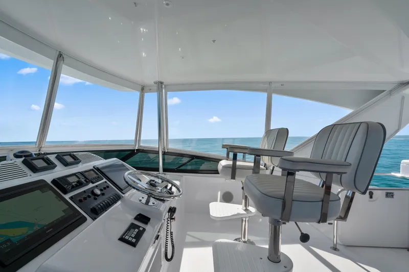 Elsewhere Yacht Photos Pics Helm of 2013 Hatteras 60 Motor Yacht with ocean view and modern controls.