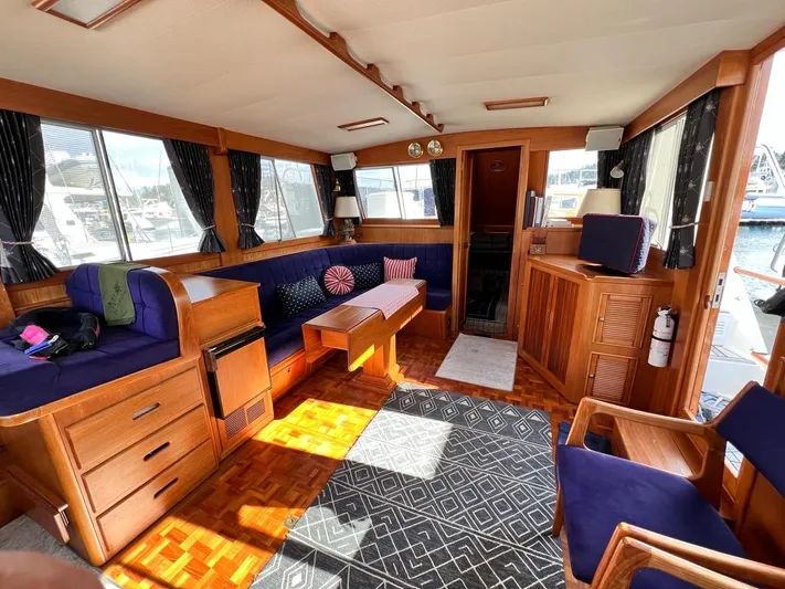  Yacht Photos Pics Luxurious interior of 1999 Grand Banks 42 Motoryacht with wood finish and blue seating.