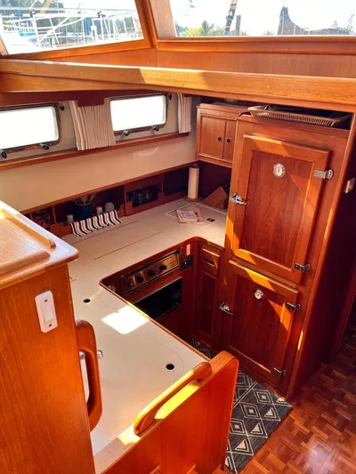  Yacht Photos Pics Interior of 1999 Grand Banks 42 Motoryacht with wooden cabinetry and compact kitchen area.