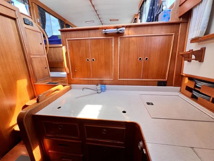  Yacht Photos Pics Interior of 1999 Grand Banks 42 Motoryacht with wooden cabinetry and countertop.