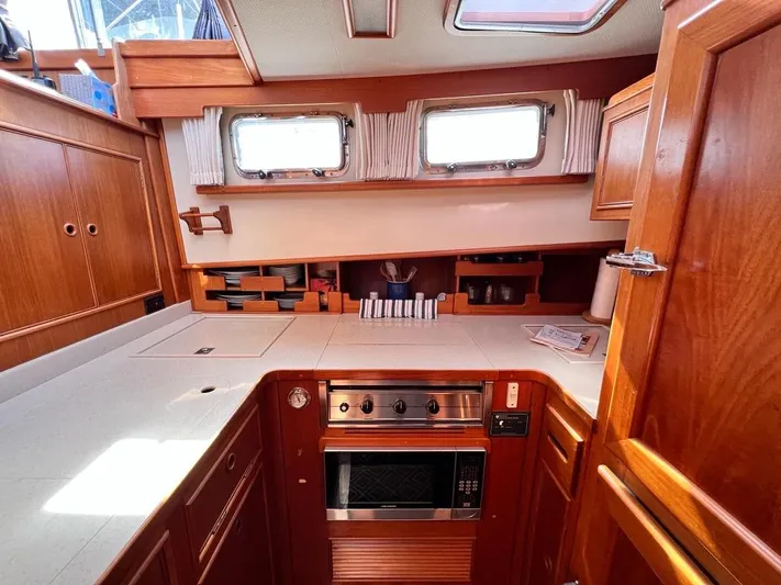  Yacht Photos Pics 1999 Grand Banks 42 Motoryacht kitchen with wood cabinetry and modern appliances.