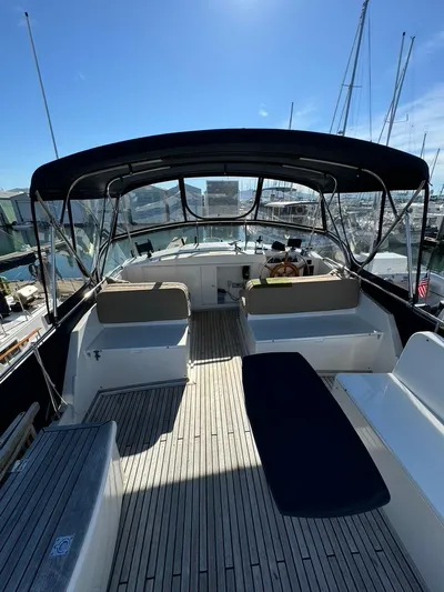  Yacht Photos Pics 1999 Grand Banks 42 Motoryacht deck with seating and helm, under a canopy.