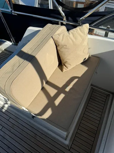  Yacht Photos Pics Beige cushioned seating on 1999 Grand Banks 42 Motoryacht deck, with wooden flooring.