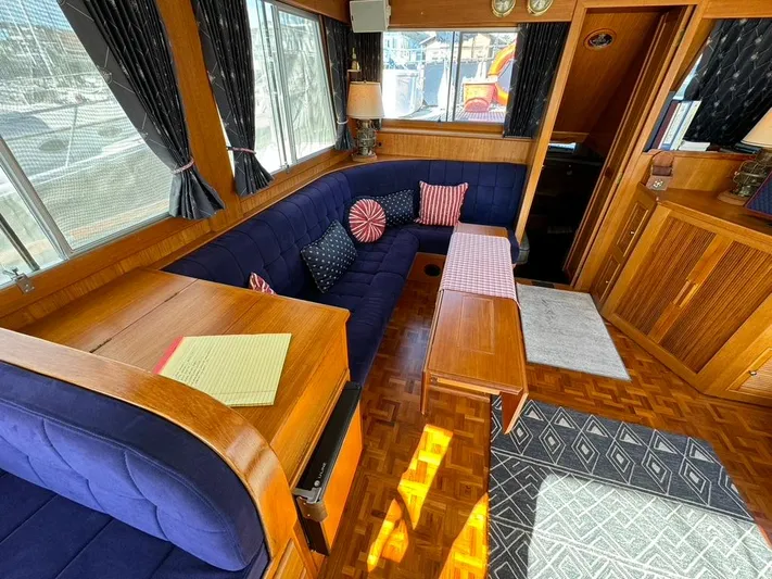  Yacht Photos Pics Interior of 1999 Grand Banks 42 Motoryacht with blue seating and wooden accents.