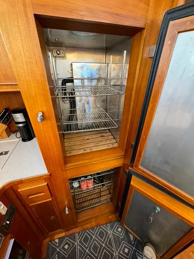  Yacht Photos Pics Interior of 1999 Grand Banks 42 Motoryacht showing wooden cabinetry and storage compartments.