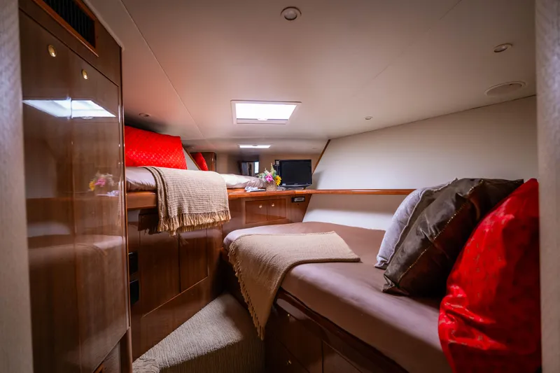  Yacht Photos Pics Luxurious cabin interior of 2005 Viking 56 yacht with cozy bedding and elegant decor.