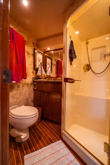  Yacht Photos Pics Bathroom interior of a 2005 Viking 56 yacht with shower and wooden accents.