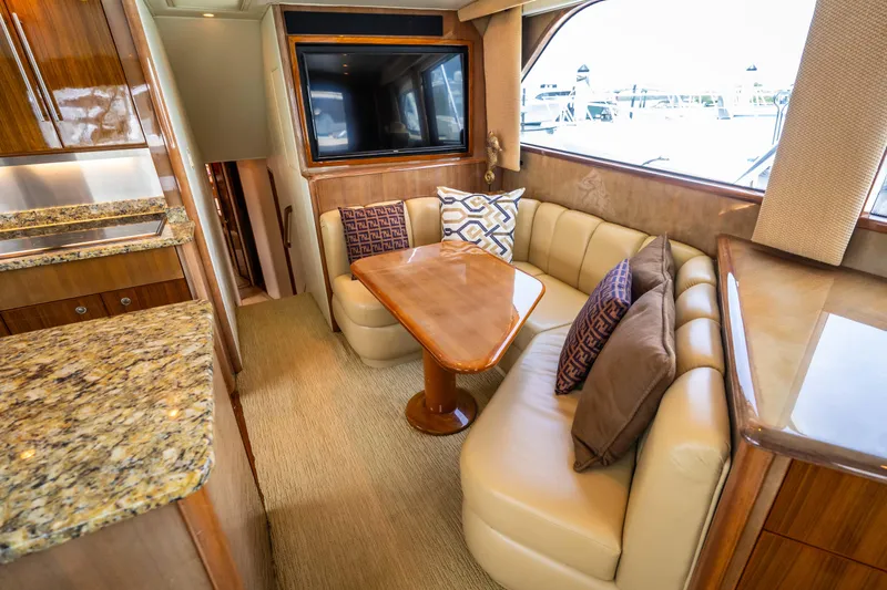 Yacht Photos Pics Luxurious 2005 Viking 56 yacht interior with plush seating and elegant wooden table.