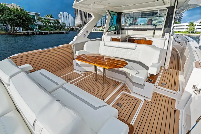 Gal Yam 3 Yacht Photos Pics Luxurious 2023 Tiara 48 LS yacht interior with elegant seating and wooden table.