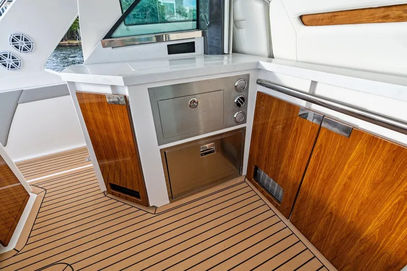 Gal Yam 3 Yacht Photos Pics Luxurious 2023 Tiara 48 LS yacht interior with sleek wood cabinetry and modern appliances.