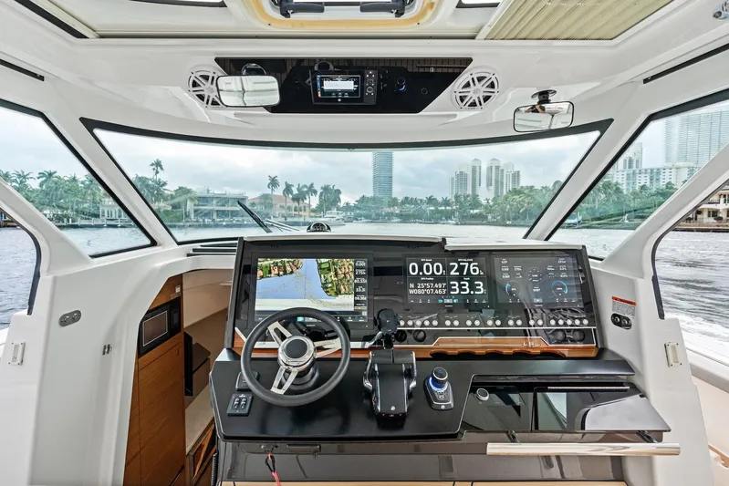 Gal Yam 3 Yacht Photos Pics 2023 Tiara 48 LS yacht helm with advanced navigation system and waterfront view.