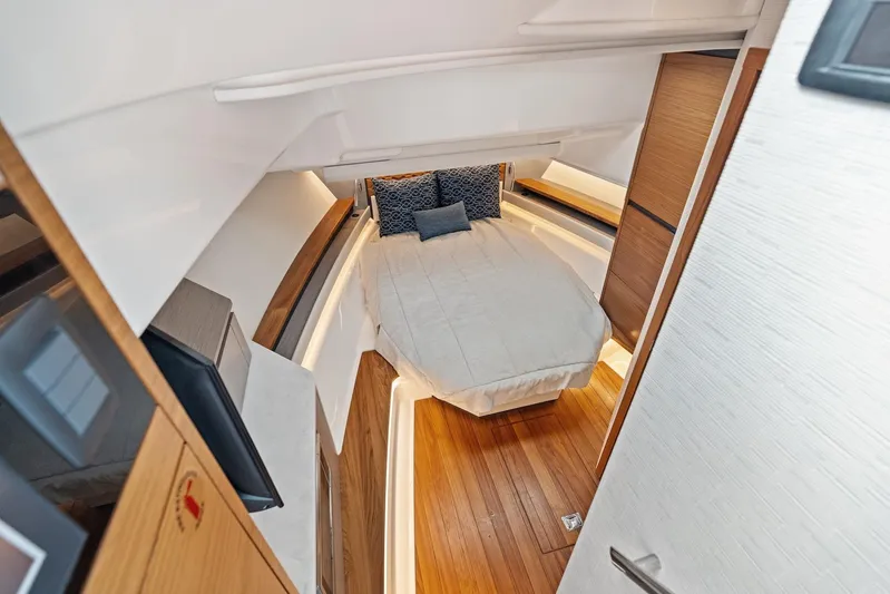 Gal Yam 3 Yacht Photos Pics Luxurious cabin interior of 2023 Tiara 48 LS yacht with cozy bed and wooden flooring.