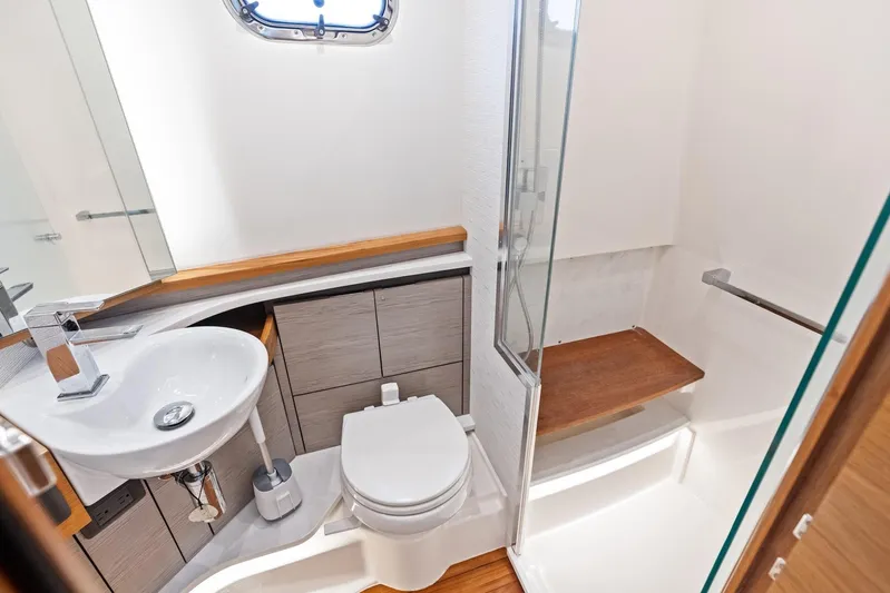 Gal Yam 3 Yacht Photos Pics 2023 Tiara 48 LS yacht bathroom with modern fixtures and wooden accents.