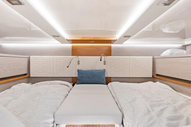 Gal Yam 3 Yacht Photos Pics Luxurious 2023 Tiara 48 LS yacht cabin with modern bedding and ambient lighting.