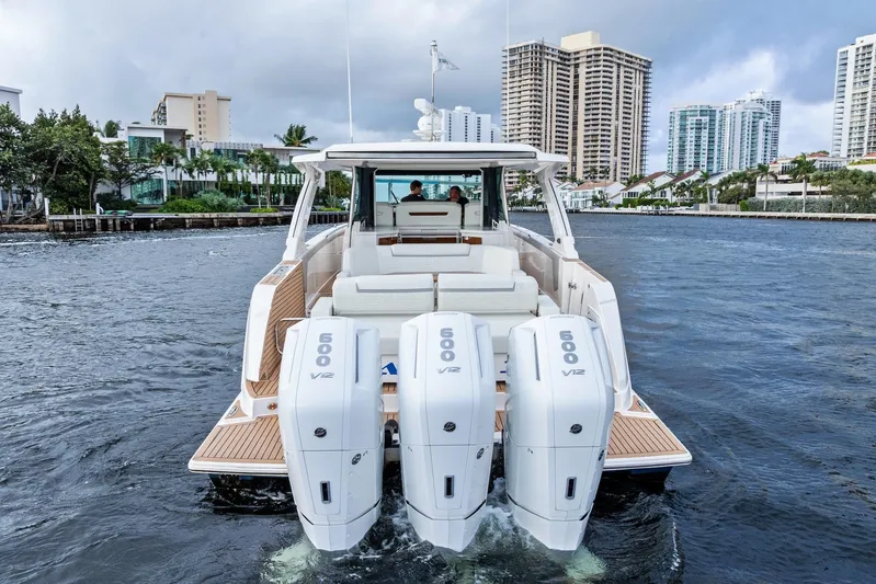 Gal Yam 3 Yacht Photos Pics 2023 Tiara 48 LS yacht with triple 600 V12 engines cruising in urban waterway.