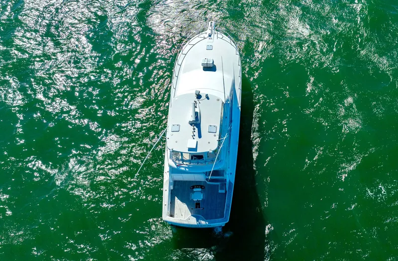 Sadie Ann II Yacht Photos Pics Aerial view of 2005 Ocean Yachts 50 Super Sport on green water.
