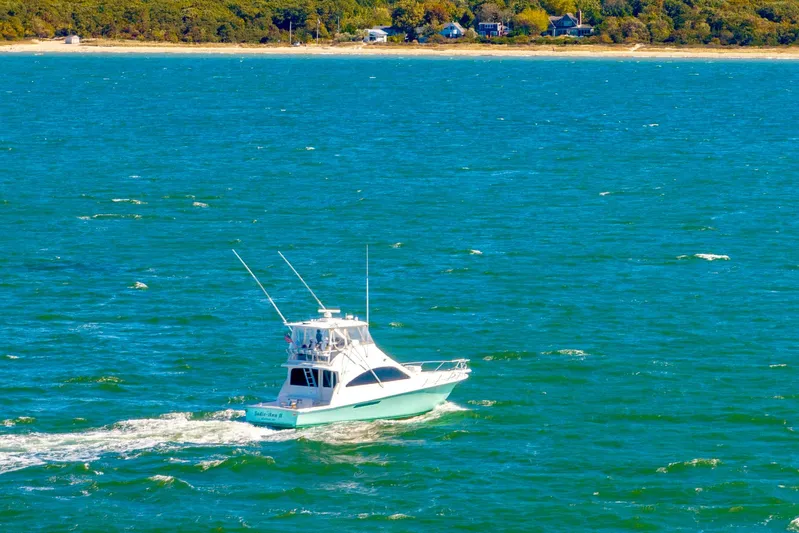 Sadie Ann II Yacht Photos Pics 2005 Ocean Yachts 50 Super Sport cruising on a vibrant blue sea.