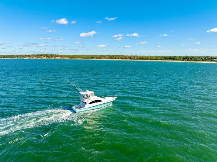 Sadie Ann II Yacht Photos Pics 2005 Ocean Yachts 50 Super Sport cruising on open water under a clear blue sky.