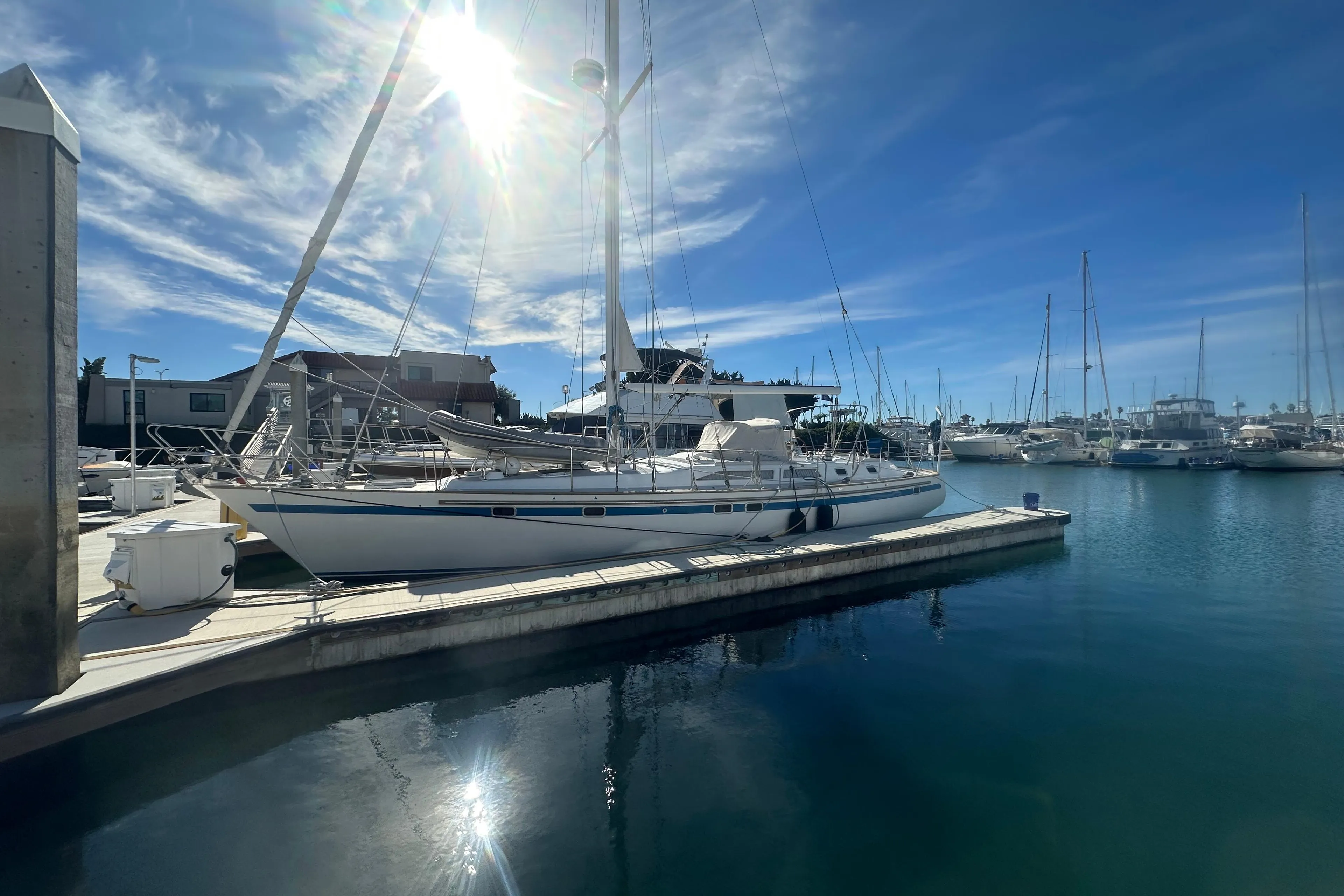 Sailboat docked in marina under sunny sky, Taswell Sloop 1991.