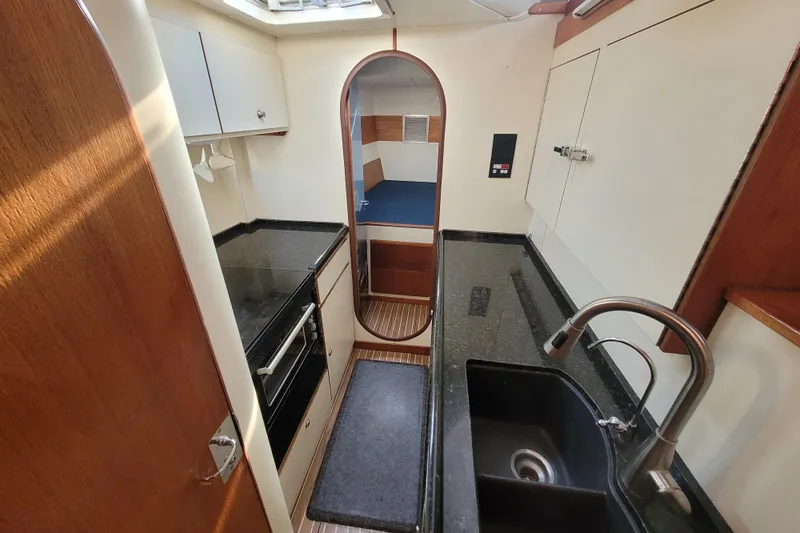 Ki Zen Yacht Photos Pics Interior of a 1995 Lagoon TPI yacht kitchen with modern amenities and sleek design.